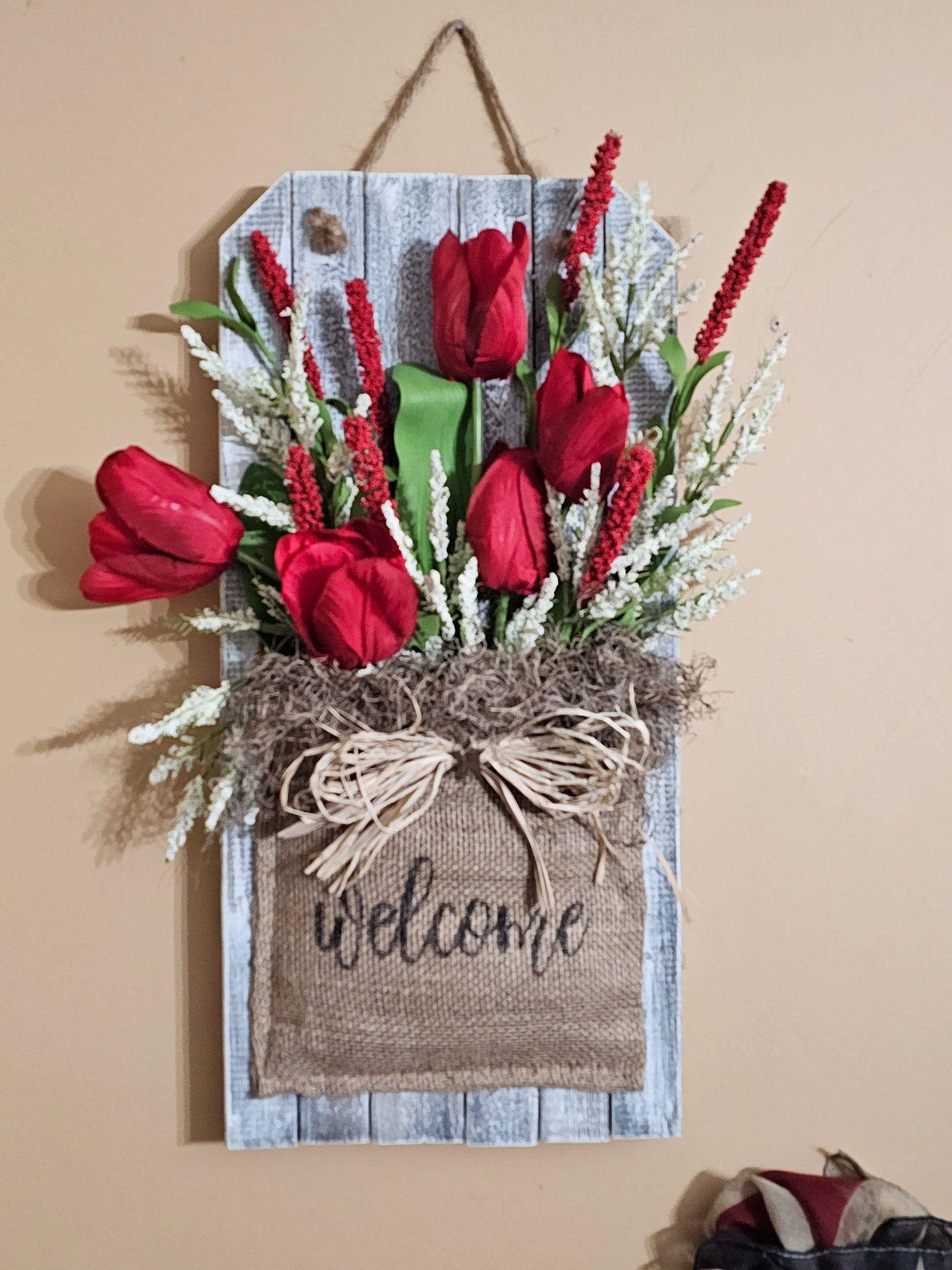 Welcome Wall Hanger with Red tulips and Red and White Florals on Wood Picket encased in a Burlap Sack.