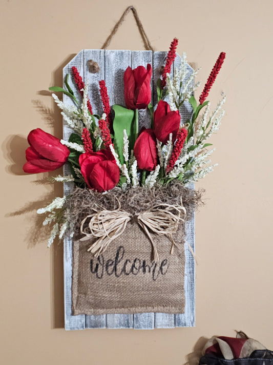 Welcome Wall Hanger with Red tulips and  Red and White Florals on Wood Picket encased in a Burlap Sack.